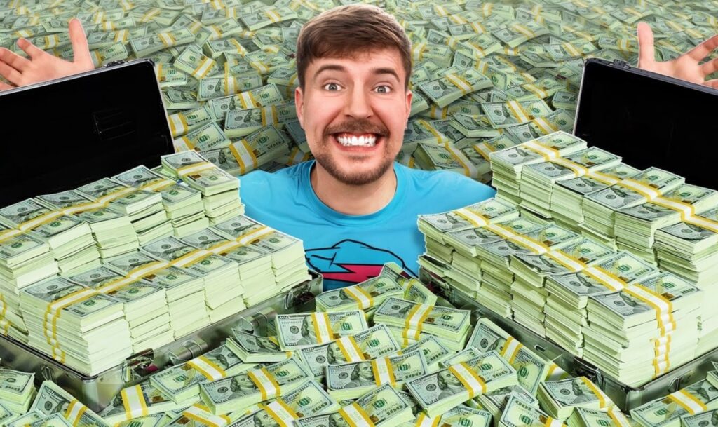MrBeast on stage with digital currency graphics symbolizing his new crypto and blockchain trademark.