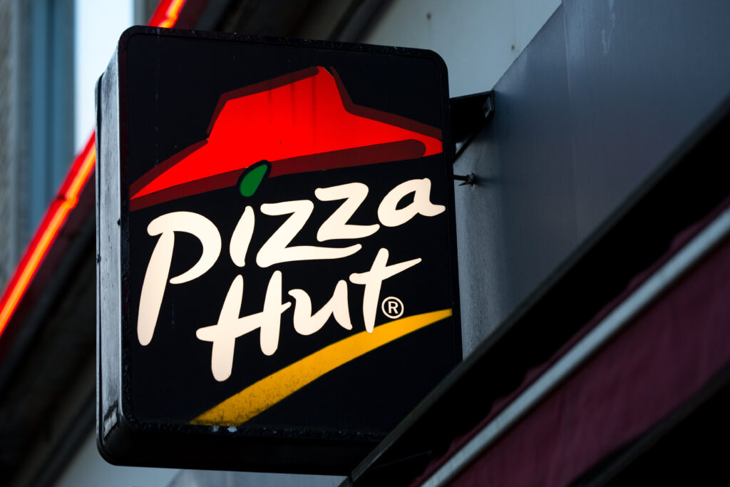 Closed Pizza Hut restaurant storefront in the UK reflecting cost-of-living crisis and layoffs.
